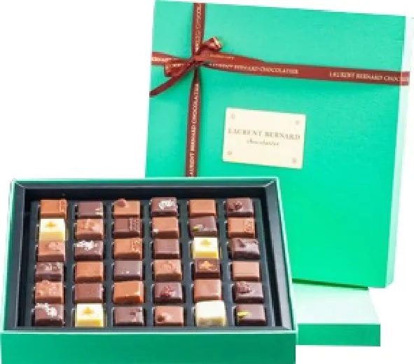 Open mint-green Laurent Bernard gift box with rows of assorted chocolates, lid tied with a red ribbon