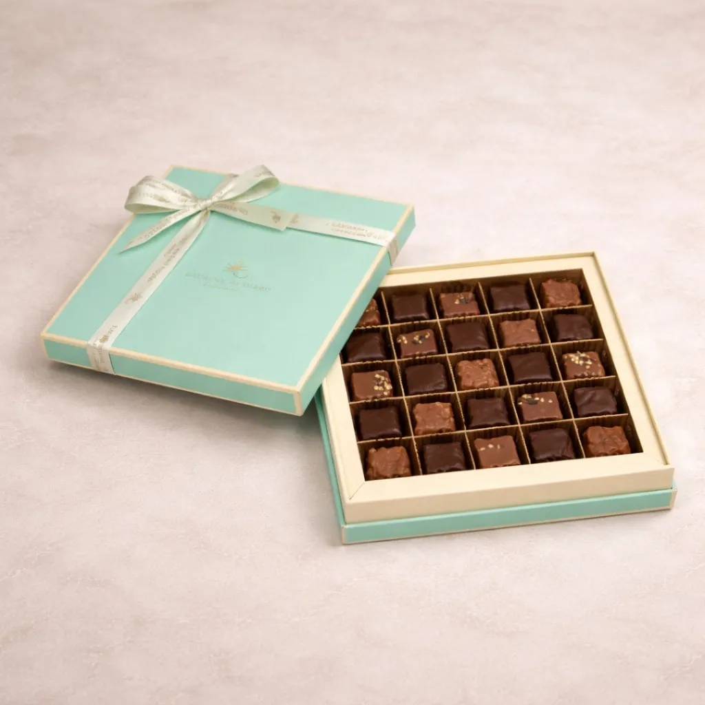 Refined assortment of luxury chocolates presented in an elegant turquoise gift box, for delivery in Singapore.
