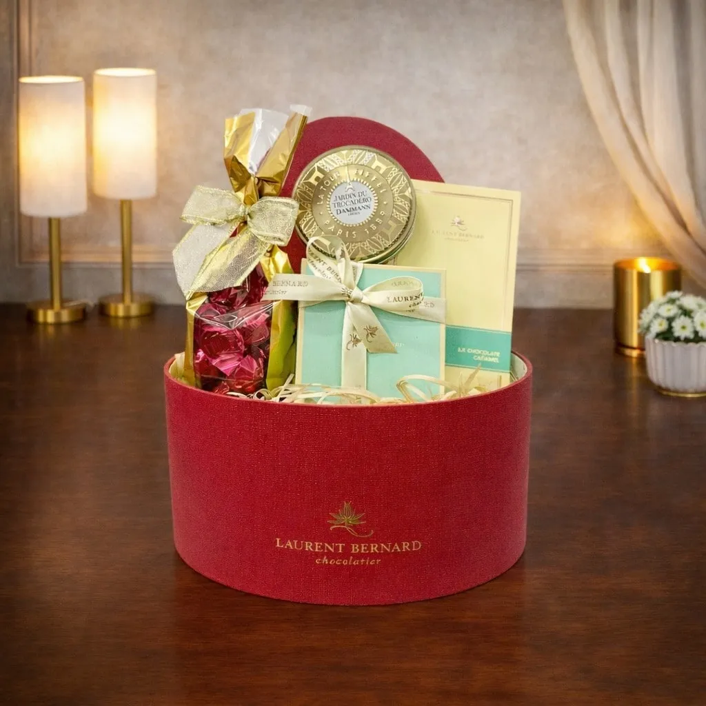 Chocolate gift hamper in red box with artisan chocolates and premium treats on elegant wooden table, singapore delivery