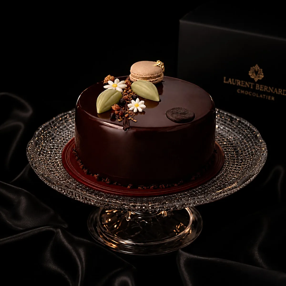 Glossy dark chocolate cake on a crystal stand, black background