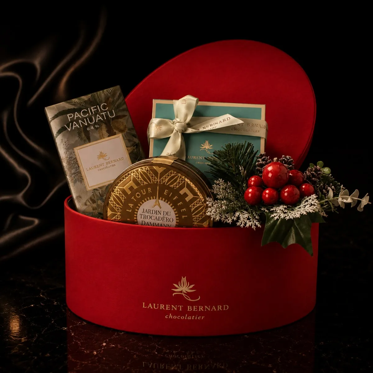 Red christmas hamper, with laurent bernard chocolatier box, tea tin, chocolate bar.
